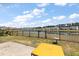 Backyard with view of the pond and houses behind, and a yellow table at 629 Snow Owl Dr, Summerville, SC 29486
