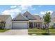 Charming home with a manicured lawn, two car garage and beautiful curb appeal at 629 Snow Owl Dr, Summerville, SC 29486