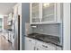 Kitchen with stainless steel appliances, gray backsplash, and black countertop at 629 Snow Owl Dr, Summerville, SC 29486