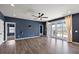 Spacious living room features wood floors, a ceiling fan, and a sliding glass door to a patio at 629 Snow Owl Dr, Summerville, SC 29486