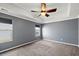 A main bedroom featuring neutral carpet, gray walls, and a ceiling fan with natural light at 629 Snow Owl Dr, Summerville, SC 29486