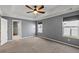 Spacious bedroom with neutral carpet, tray ceiling, fan and large windows allows natural light at 629 Snow Owl Dr, Summerville, SC 29486
