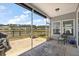 Screened in patio with ceiling fan overlooking landscaped backyard and pond at 629 Snow Owl Dr, Summerville, SC 29486