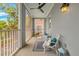 Relaxing outdoor balcony with seating, ceiling fan, and serene neighborhood views at 656 Coleman Blvd # 405, Mount Pleasant, SC 29464