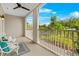 Outdoor balcony with seating, ceiling fan, and serene views of lush greenery at 656 Coleman Blvd # 405, Mount Pleasant, SC 29464