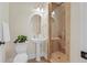 Charming bathroom featuring a pedestal sink, tiled shower, and neutral decor at 656 Coleman Blvd # 405, Mount Pleasant, SC 29464