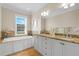 Bathroom featuring double sinks, a soaking tub, and granite counters at 656 Coleman Blvd # 405, Mount Pleasant, SC 29464