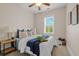 Cozy bedroom with a ceiling fan, bright window, and soft, inviting bedding at 656 Coleman Blvd # 405, Mount Pleasant, SC 29464