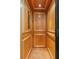 A cozy wood-paneled elevator with recessed lights and folding safety gate at 656 Coleman Blvd # 405, Mount Pleasant, SC 29464