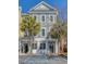 Three-story townhome with a blue-gray facade, white trim, and palm trees in the front at 656 Coleman Blvd # 405, Mount Pleasant, SC 29464