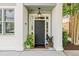 Inviting front entrance featuring a stylish black door, sidelights, transom window and potted plants at 656 Coleman Blvd # 405, Mount Pleasant, SC 29464