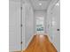 Hallway features hardwood floors, white trim, and leads to a bedroom with a ceiling fan at 656 Coleman Blvd # 405, Mount Pleasant, SC 29464
