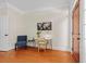 Bright home office with hardwood floors, a modern desk, and a comfortable blue accent chair at 656 Coleman Blvd # 405, Mount Pleasant, SC 29464