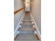 Carpeted staircase with white wood trim and a matching wood handrail at 656 Coleman Blvd # 405, Mount Pleasant, SC 29464