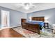 Bedroom with hardwood floors, colorful rug, ceiling fan and wooden bed frame at 7 Sconesill Ln, Charleston, SC 29414