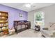 Cozy Bedroom with wooden crib, bookshelf, and cushioned rocking chair at 7 Sconesill Ln, Charleston, SC 29414