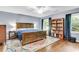 Bedroom with hardwood floors, ceiling fan, wooden bed frame and bookshelf at 7 Sconesill Ln, Charleston, SC 29414