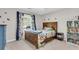 Bedroom with a wooden bed, dinosaur-themed curtains, and a dinosaur wall decal at 7 Sconesill Ln, Charleston, SC 29414