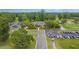 Aerial view of the community clubhouse with golf carts and cars in the parking lot at 7 Sconesill Ln, Charleston, SC 29414