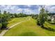 Aerial view of expansive golf course with manicured lawns and trees at 7 Sconesill Ln, Charleston, SC 29414
