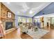Bright living room with a stone fireplace, vaulted ceiling, and hardwood floors at 7 Sconesill Ln, Charleston, SC 29414