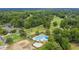 Overhead shot of the pool with an adjacent golf course surrounded by mature trees at 7 Sconesill Ln, Charleston, SC 29414