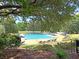 A serene community pool surrounded by lush greenery and comfortable lounge chairs at 7 Sconesill Ln, Charleston, SC 29414