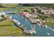Scenic aerial view of a coastal town with boats docked along the riverfront and vibrant waterfront buildings at 707 Royall Ave, Mount Pleasant, SC 29464
