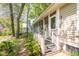 View of a screened-in porch with wooden steps leading down to a landscaped yard at 707 Royall Ave, Mount Pleasant, SC 29464