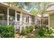 Rear exterior view featuring a screened-in porch and outdoor living space at 707 Royall Ave, Mount Pleasant, SC 29464