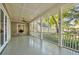 A screened-in back porch featuring overhead fan, white columns, and green painted flooring at 707 Royall Ave, Mount Pleasant, SC 29464