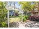 Backyard view with a charming pergola, green lawn, and well-maintained landscaping at 707 Royall Ave, Mount Pleasant, SC 29464