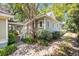 Charming exterior view of a light green home showcasing manicured landscaping and mature trees at 707 Royall Ave, Mount Pleasant, SC 29464
