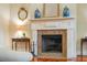 Close up of fireplace showcasing a beautiful mantle, granite hearth, and decorative accents at 707 Royall Ave, Mount Pleasant, SC 29464