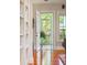 Inviting foyer with hardwood floors leads to a screened porch with views of lush greenery at 707 Royall Ave, Mount Pleasant, SC 29464