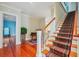 Grand foyer with hardwood floors, staircase with runner, and piano at 707 Royall Ave, Mount Pleasant, SC 29464
