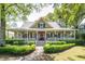Charming home featuring a welcoming front porch, manicured landscaping, and an inviting entrance at 707 Royall Ave, Mount Pleasant, SC 29464