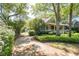 Charming home with a welcoming front porch, mature trees, and a well-manicured lawn at 707 Royall Ave, Mount Pleasant, SC 29464