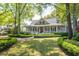Charming home with a large front porch, traditional architecture, and beautiful landscaping at 707 Royall Ave, Mount Pleasant, SC 29464
