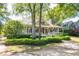 Charming home featuring a covered porch, manicured hedges, and a welcoming facade, great for curb appeal at 707 Royall Ave, Mount Pleasant, SC 29464