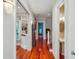 Bright hallway with hardwood floors, built-in shelving, and an antique grandfather clock at 707 Royall Ave, Mount Pleasant, SC 29464
