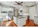 Open kitchen design with central island, stainless steel appliances, and adjacent wine cooler at 707 Royall Ave, Mount Pleasant, SC 29464