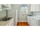 Functional laundry room features a stainless steel sink, cabinets, and a laundry machines at 707 Royall Ave, Mount Pleasant, SC 29464