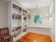 Cozy office nook features a window bench, white built-in shelving, and hardwood floors at 707 Royall Ave, Mount Pleasant, SC 29464