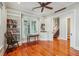 Sunlit office featuring built-in bookshelves, hardwood flooring, and large windows at 707 Royall Ave, Mount Pleasant, SC 29464