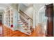 Staircase with carpet runner, hardwood floors, and white banister at 707 Royall Ave, Mount Pleasant, SC 29464