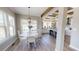 Bright dining area with a round white table and a view of the modern kitchen at 966 Tiger Loop, Saint Stephen, SC 29479