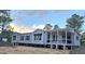 Charming manufactured home featuring a welcoming front porch with white railing at 966 Tiger Loop, Saint Stephen, SC 29479