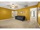Spacious bonus room offering versatility with a sofa, neutral walls and carpeted flooring at 9759 Seed St, Ladson, SC 29456