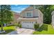Charming two-story home with a well-maintained lawn and a two car garage at 9759 Seed St, Ladson, SC 29456